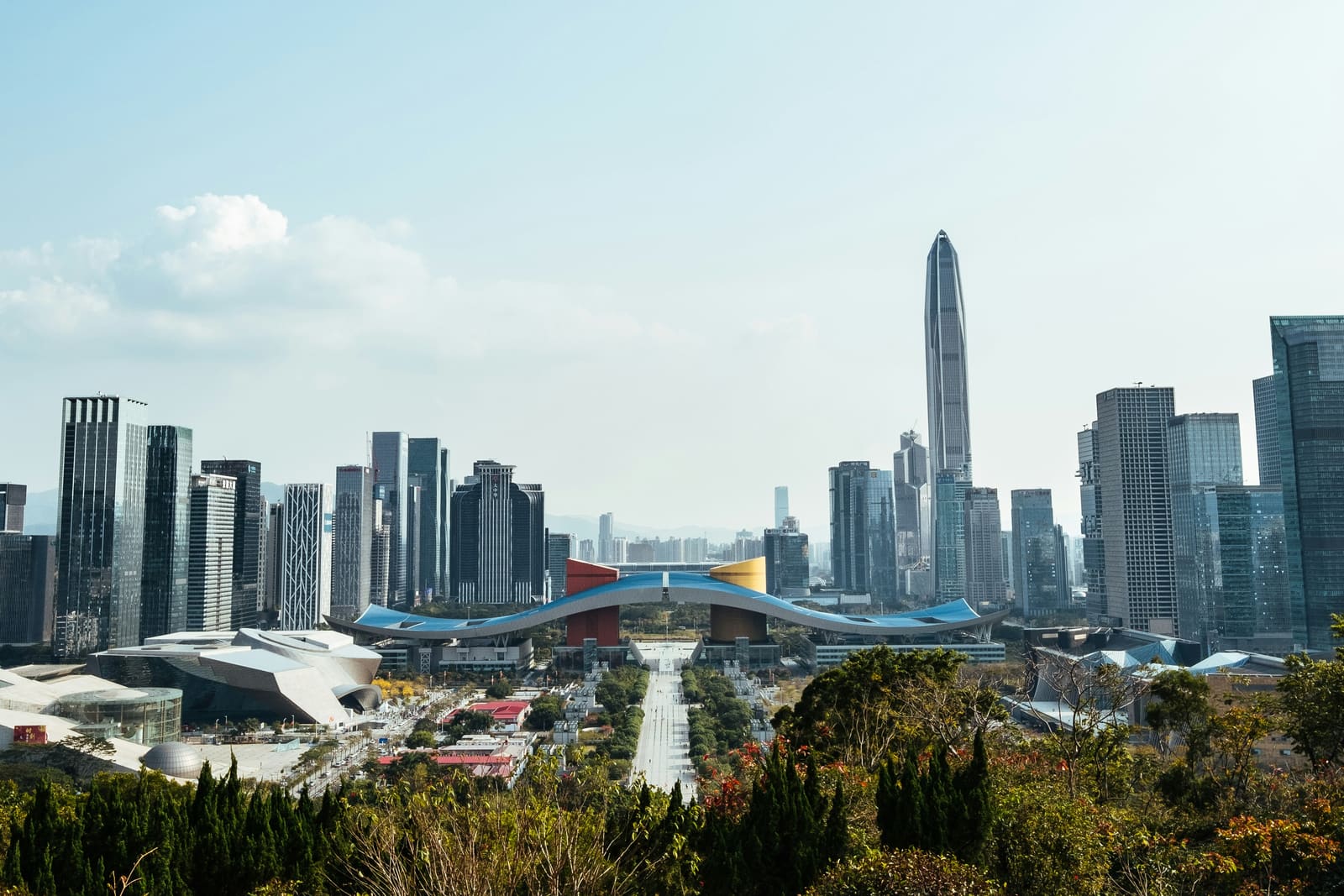 Traveler using a phone with Shanghai skyline in the background